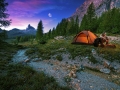 Mystical night landscape, in the foreground hike, campfire and tent