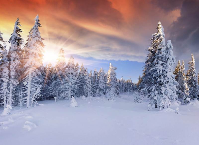 Beautiful winter sunrise in the mountains. Dramatic red sky